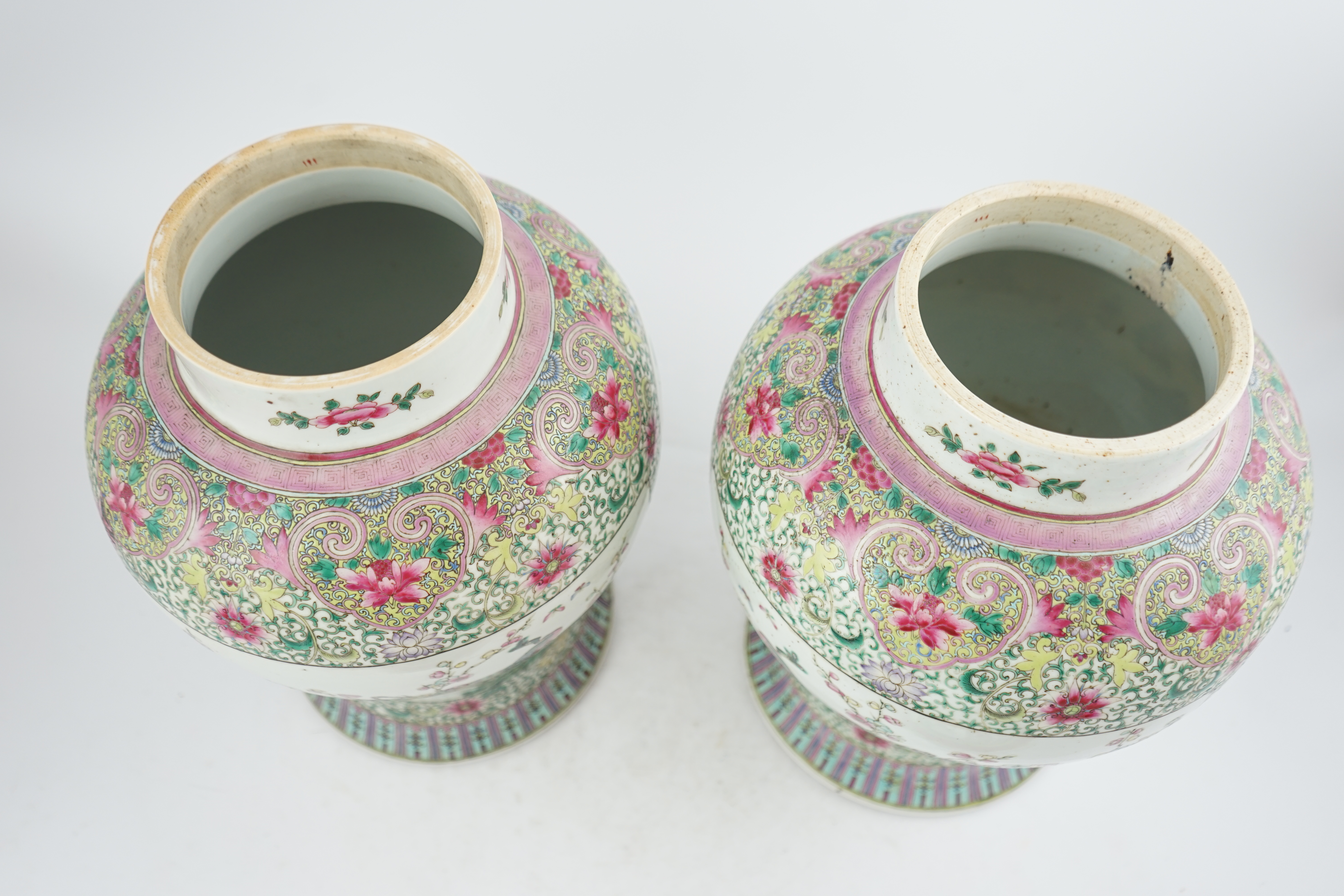 A pair of large Chinese famille rose baluster jars and covers, Qianlong seal mark, but late 19th century